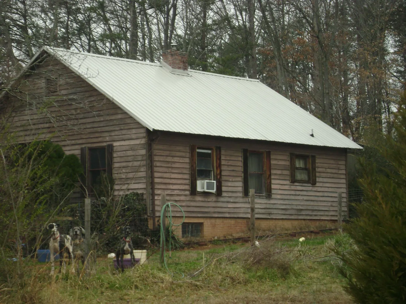 White metal roof on an old wood sided farmhouse, from a Metal Roof Installation job in New Brighton